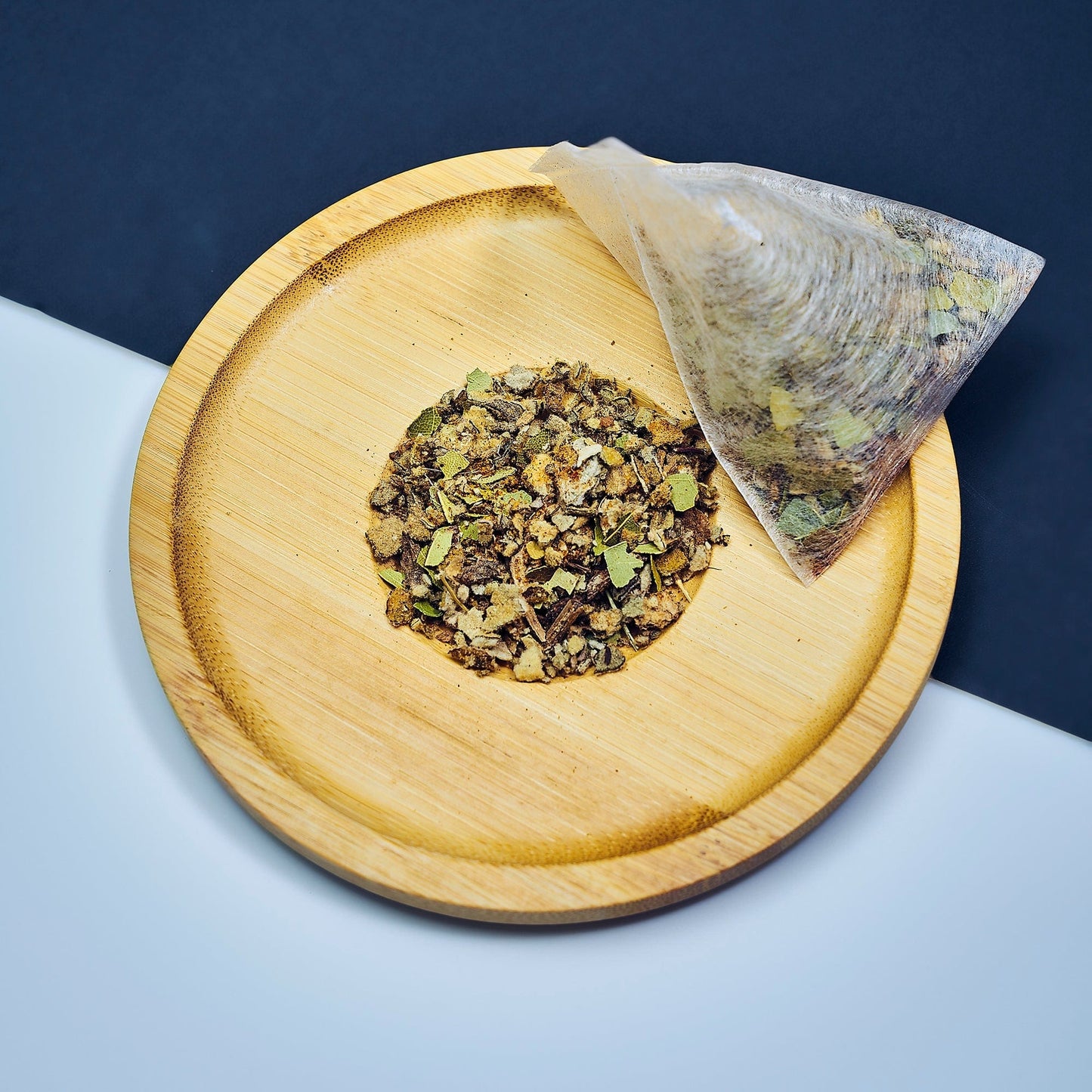 "Smooth September herbal tea blend with cayenne pepper, bay leaf, and mullein in biodegradable tea sachet bags inside a 16oz resealable pouch, displayed beside a steaming tea mug."