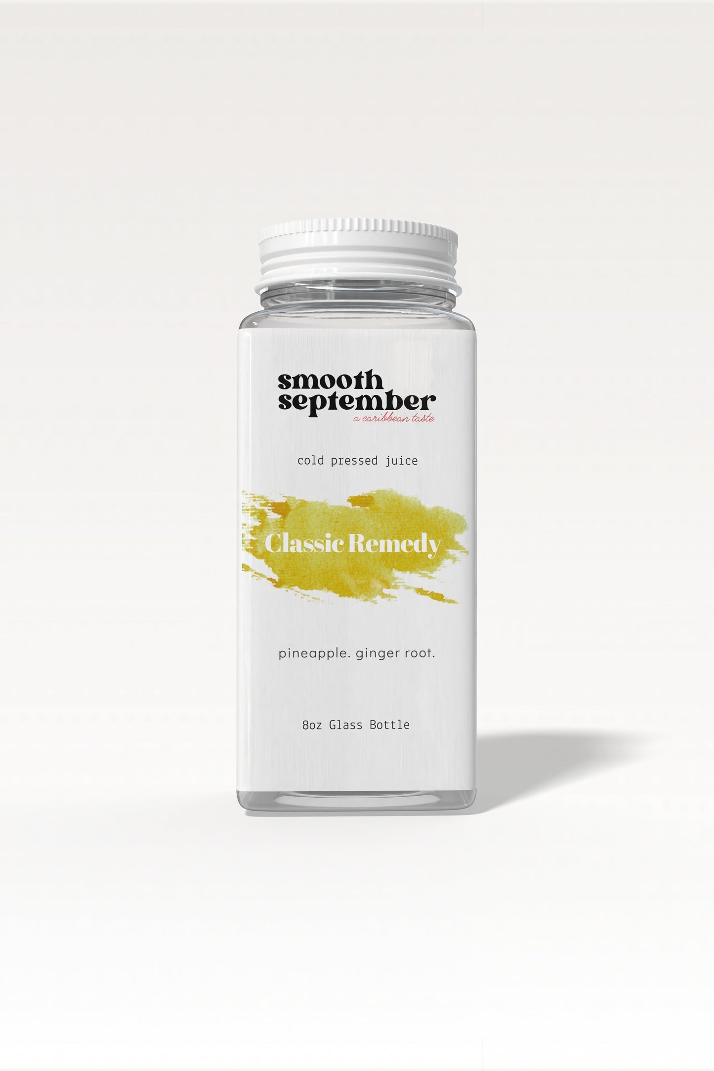A bottle of Classic Remedy cold-pressed juice with pineapple and ginger, shown next to fresh slices of pineapple.