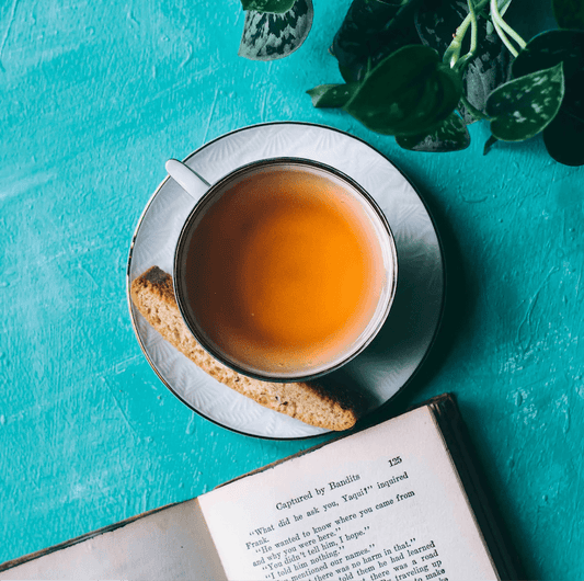 Smooth September soursop leaf and ginger root herbal tea in biodegradable tea sachet bags, displayed inside a 16oz resealable pouch beside a tea mug.