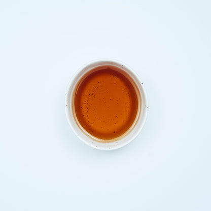 A vibrant cup of Awakening Herbal Tea Blend from Our Tea Collection, featuring bay leaf, cayenne, and mullein, perfect for respiratory wellness and immune support, part of a range of health teas and herbal tea infusions.