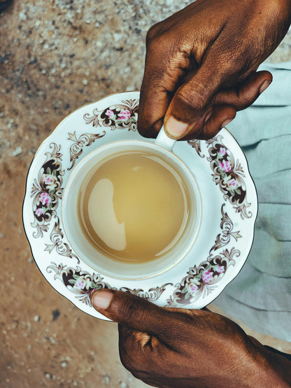 Enjoy a cup of Sana Herbal Tea from Our Tea Collection, crafted with organic ingredients like soursop leaf and ginger root. This herbal tea blend supports relaxation and rejuvenation, perfect for those seeking caffeine-free tea options and herbal blends for health.
