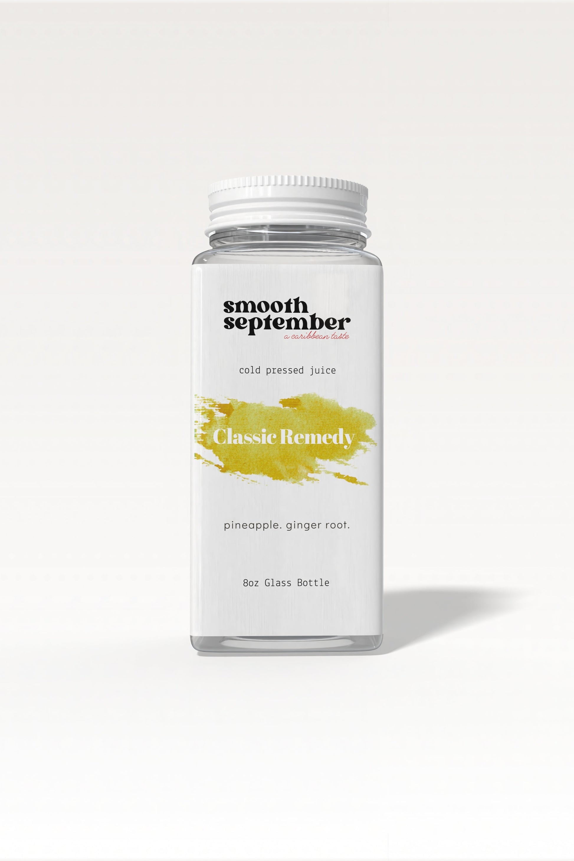 A bottle of Classic Remedy cold-pressed juice with pineapple and ginger, shown next to fresh slices of pineapple.