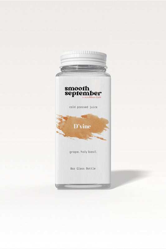 A bottle of D’vine cold-pressed juice, showcasing its deep brown color from grapes and holy basil.