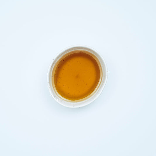 Smooth September, A natural herbal arrangement featuring dandelion leaf, fresh ginger root, nettle leaves, chamomile flowers, and dried burdock root on a white surface.