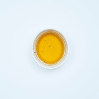 A steaming cup of Mineral-Rich Detox Herbal Tea from Our Tea Collection, highlighting its mineral-packed ingredients. Ideal for those seeking organic healthy drinks, herbal blend tea, elderberry tonic, and a caffeine-free tea experience.