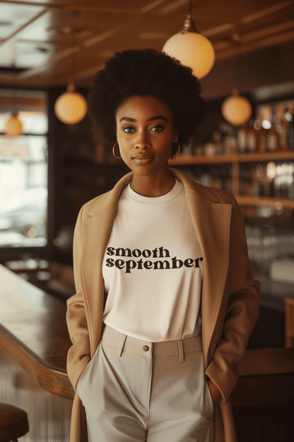 Smooth September Soft Cotton T-Shirt in Sand color, inspired by Caribbean culture, showcasing a vibrant design that embodies comfort and style, perfect for pairing with organic healthy drinks or enjoying a refreshing herbal tea infusion.