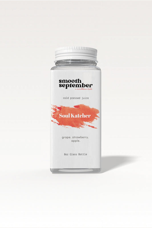 A photo of the Soul Katcher Cold-Pressed Juice bottle, showcasing its label with a blend of strawberry, apple, and grape.
